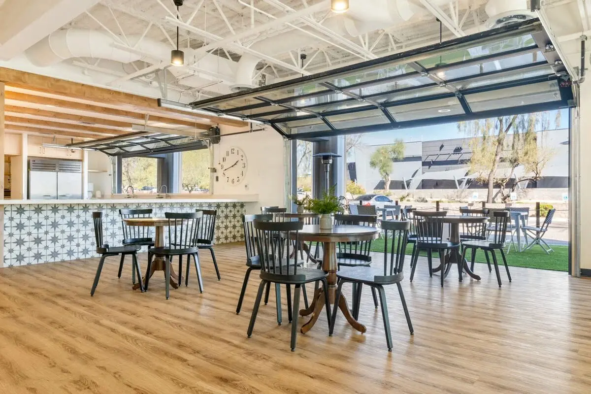 Open dining and gathering area with glass garage-style doors