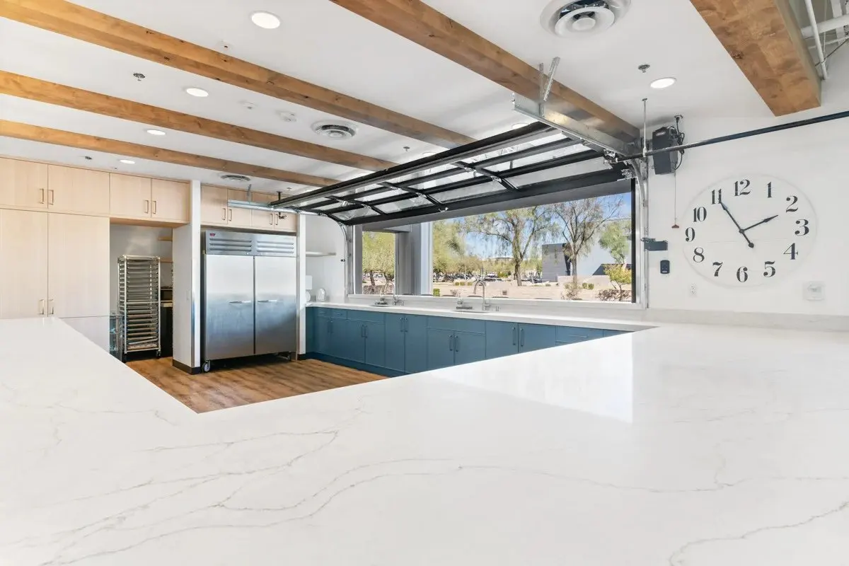Hospitality kitchen with stainless refrigeration and blue cabinetry