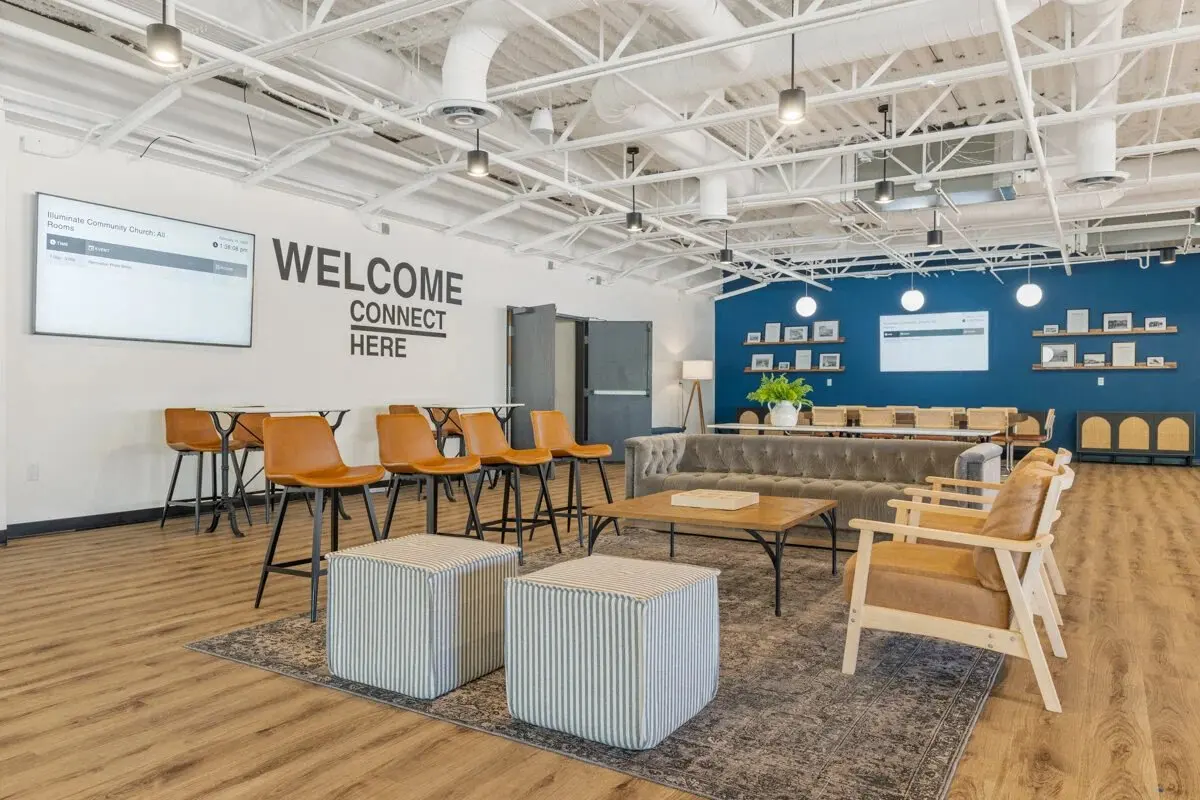 Illuminate Community Church connect lounge with leather seating and blue shelving