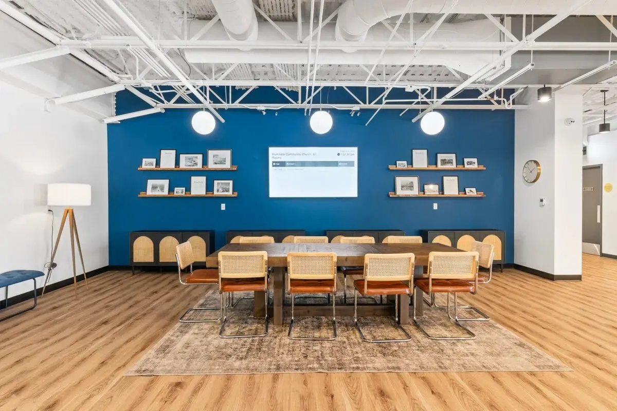 Church meeting room with a deep-blue feature wall and built-in shelving
