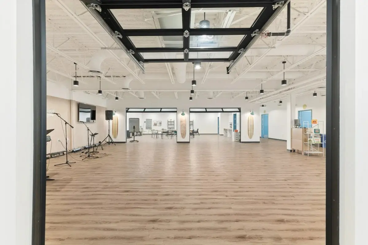 Large multipurpose room with wood-look flooring