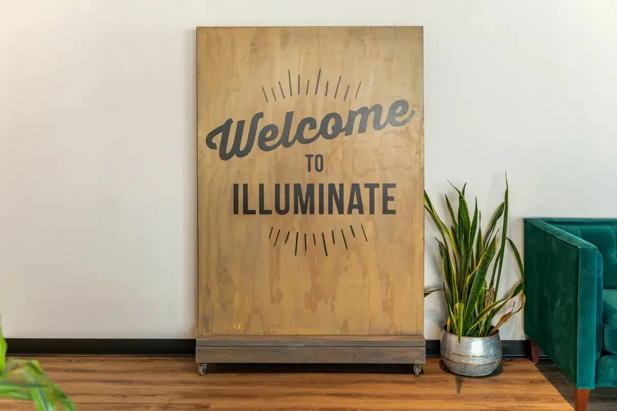 Wood welcome sign inside Illuminate Community Church